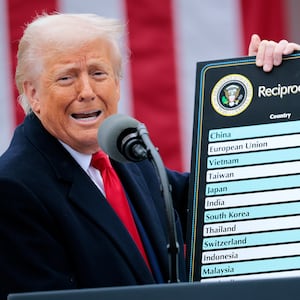 U.S. President Donald Trump holds up a chart.