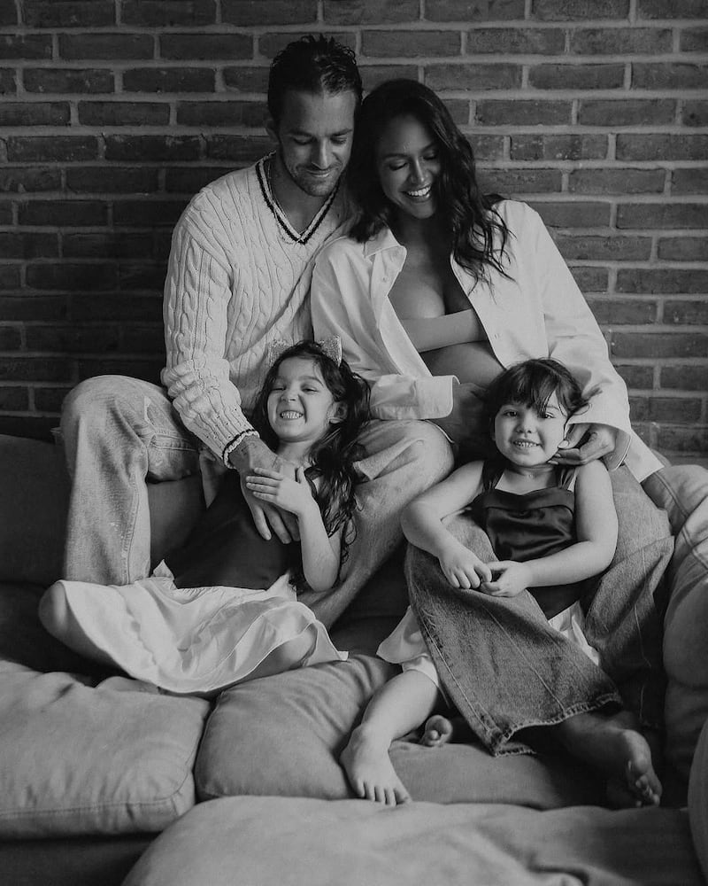 A pregnant Cassie Ventura and her husband Alex Fine pose with their two children in a photo posted to Instagram on February 19, 2025.