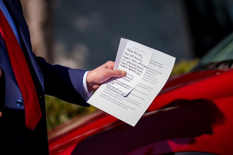 Trump was pictured holding notes on the pricing and features of Tesla vehicles during the bizarre White House appearance.