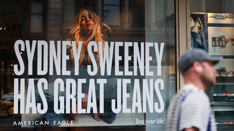 A window display of actress Sydney Sweeney is seen on a window of an American Eagle store on August 01, 2025 in New York City. American Eagle’s recent denim ad campaign featuring  Sweeney has drawn backlash for language and imagery that critics say echoes eugenics-era rhetoric, following a tagline referencing “great genes” alongside visuals of Sweeney in blue jeans.