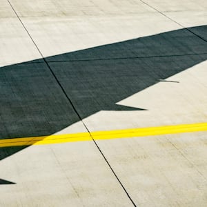 Shadow of an airplane wing on the runway.