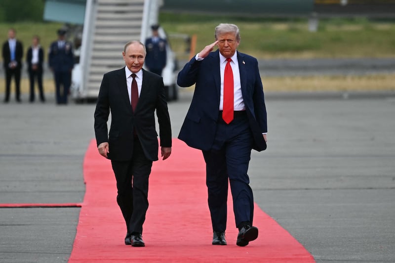 US President Donald Trump salutes as he walks with Russian President Vladimir Putin on the tarmac after they arrived at Joint Base Elmendorf-Richardson in Anchorage, Alaska, on August 15, 2025. Putin is in Alaska at the invitation of Trump in his first visit to a Western country since he ordered the 2022 invasion of Ukraine that has killed tens of thousands of people. (Photo by ANDREW CABALLERO-REYNOLDS / AFP) (Photo by ANDREW CABALLERO-REYNOLDS/AFP via Getty Images)