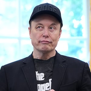 Elon Musk, sporting a black eye given to him by his son X, listens as President Donald Trump speaks to reporters in the Oval Office of the White House on May 30, 2025.