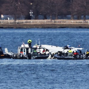 Emergency workers recover debris from the Potomac River in the aftermath of the collision of American Eagle flight 5342 and a Black Hawk helicopter, as seen from Virginia, U.S., January 30, 2025.