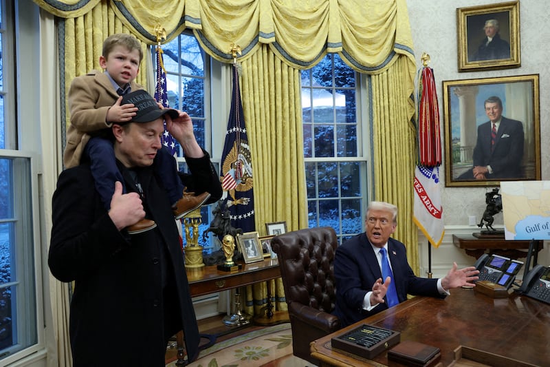 President Donald Trump speaks as Elon Musk carries his son X Æ A-12 on his shoulders in the Oval Office of the White House in Washington, D.C. on February 11, 2025.