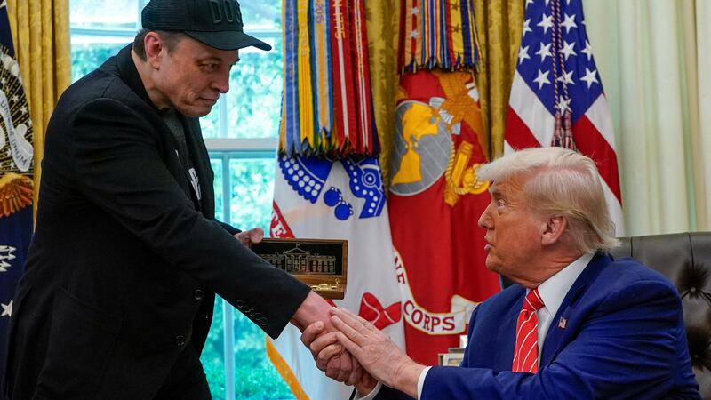 Elon Musk receives a golden key from U.S. President Donald Trump in the Oval Office at the White House in Washington, D.C., U.S., May 30, 2025. REUTERS/Nathan Howard