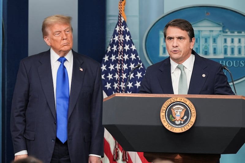 U.S. Deputy Attorney General Todd Blanche speaks to the media as U.S. President Donald Trump listens.