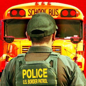Border Patrol agents in front of school buses.
