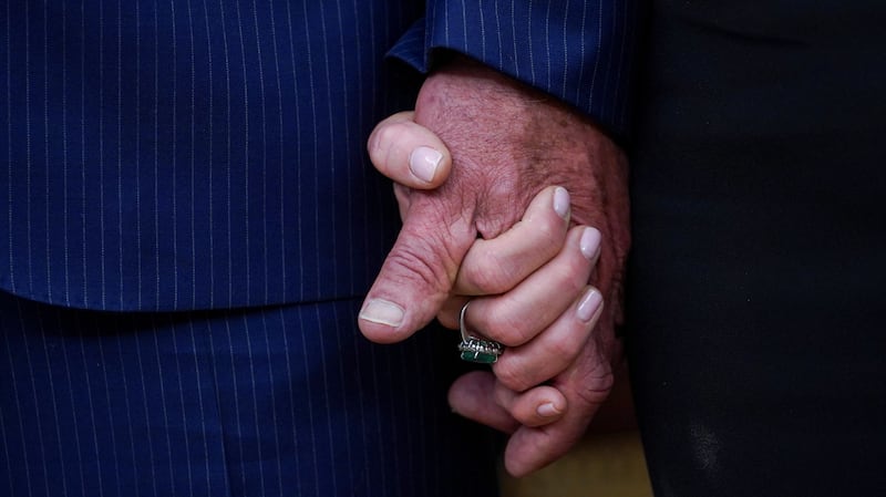 Robert F. Kennedy Jr. holds the hand of his wife Cheryl Hines, on the day Kennedy is sworn in as secretary of Health and Human Service in Washington, D.C., U.S., February 13, 2025. REUTERS/Nathan Howard