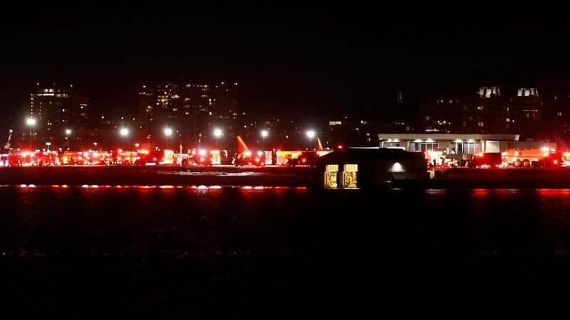 Lights from emergency vehicles are seen at Reagan National Airport after an air crash near the Potomac River.