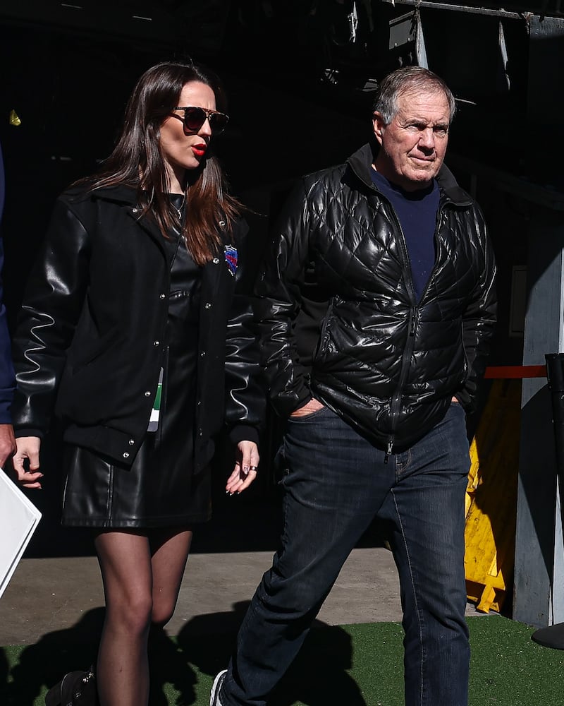 Bill Belichick, 72, and girlfriend Jordon Hudson, 24, enter the field before a college football game this fall.