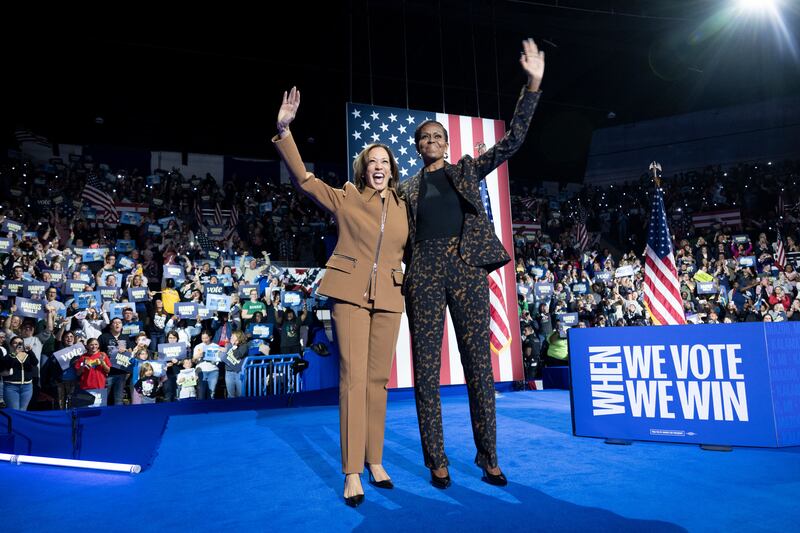 US Vice President and Democratic presidential candidate Kamala Harris and former US First Lady Michelle Obama campaign together at the Wings Event Center in Kalamazoo, Michigan, October 26, 2024.