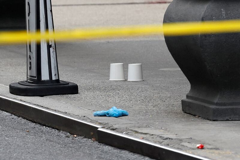 Cups mark the location of shell casings found at the scene where the CEO of United Healthcare Brian Thompson was reportedly shot and killed in Midtown Manhattan, in New York City, US, December 4, 2024