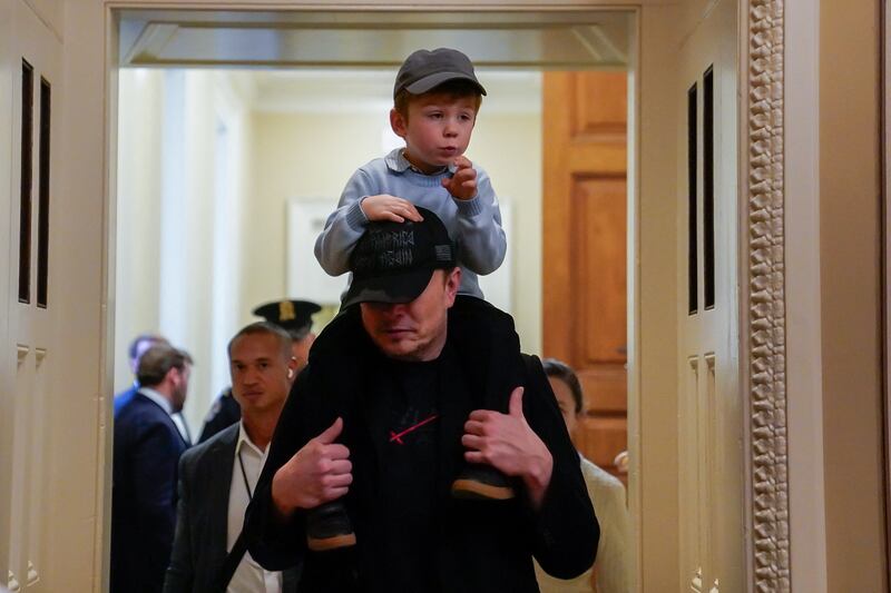 Tesla CEO Elon Musk and his son X Æ A-12 depart the U.S. Capitol after meeting with lawmakers, including Senate Commerce Committee members, at the U.S. Capitol in Washington, D.C., U.S., May 21, 2025. REUTERS/Elizabeth Frantz