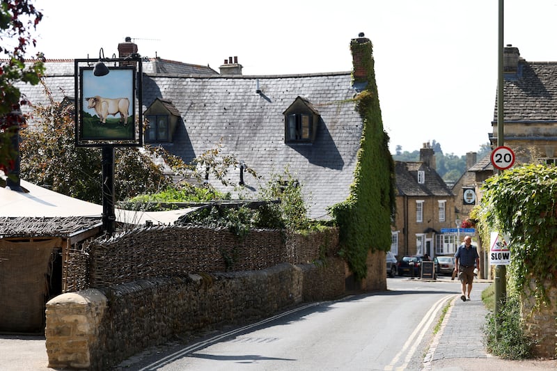 A person walks near the Bull Pub in the centre of the town of Charlbury, as U.S. Vice President JD Vance spends his holiday nearby, in Charlbury, Cotswolds, Britain, August 11, 2025. REUTERS/Toby Melville