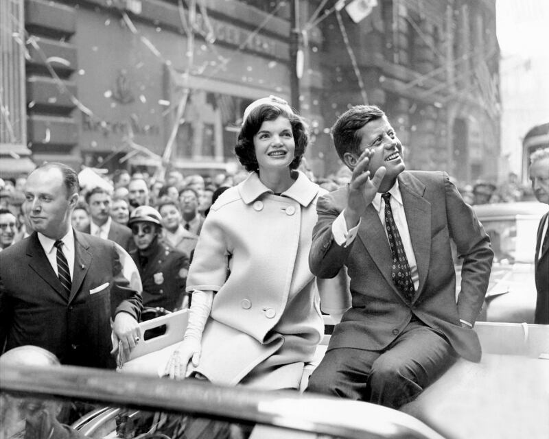 John F. Kennedy and his wife, Jacqueline, ride up Broadway in a ticker-tape parade.